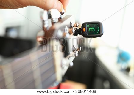 Tuner Is Installed On Guitar Neck For Tuning Notes. Tuner For An Acoustic Guitar. Each String Makes 