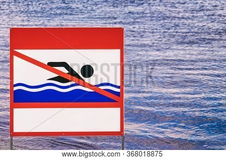 Sign On The Riverbank Swimming Is Prohibited, A Prohibiting Sign Indicates The Prohibition Of Swimmi