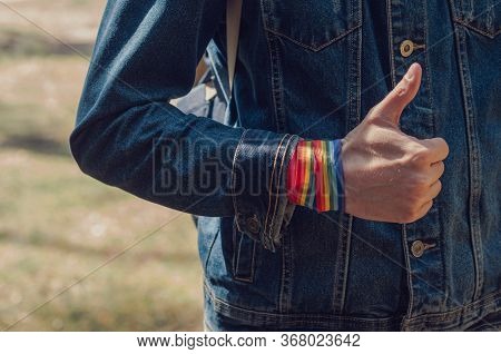 Man Showing Hand With Rainbow Ribbon With Thumbs Up. Concept Of Lgbt Pride, Rights Campaign, Equalit