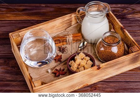 Ingredients For Dalgon Coffee In A Box On A Wooden Background. Instant Coffee, Anise, Cinnamon, Cane