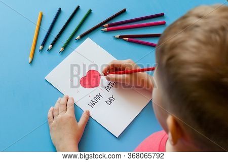 The Child Makes Crafts Out Of Paper Boats. Greeting Card For On Father's Day. Made With His Own Hand