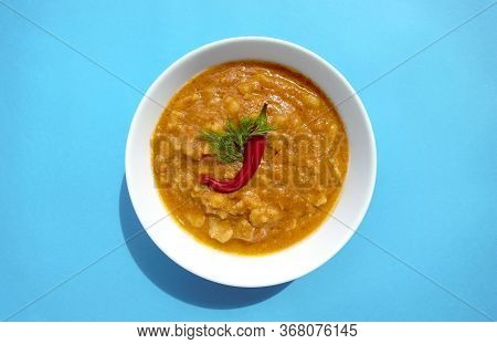 Famous Traditional Arabic Cuisine - Peeled Fava Beans With Chili In White Bowl On Blue Background. T