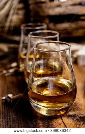 Speyside Scotch Whisky Tasting On Old Dark Wooden Vintage Table With Barley Grains Close Up