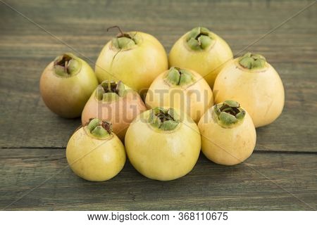 Rose Apple - Syzygium Jambos. Wood Background