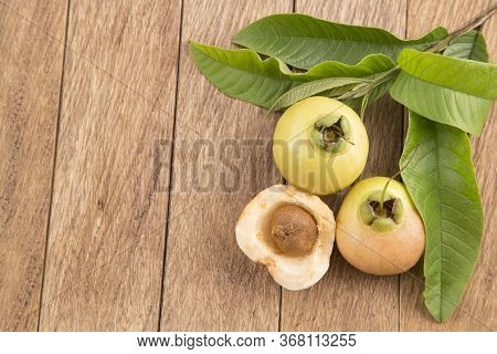 Rose Apple - Syzygium Jambos. Wood Background