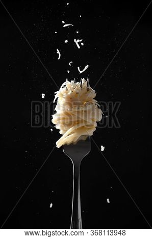 Fork With Spaghetti Sprinkled Cheese And Pepper On Dark Background. Cacio E Pepe - Italian Pasta