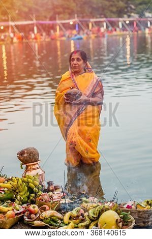 Kathmandu,nepal - November 1,2019: Hindu Devotee Offering Prayers To Sun God Standing In Water Accor