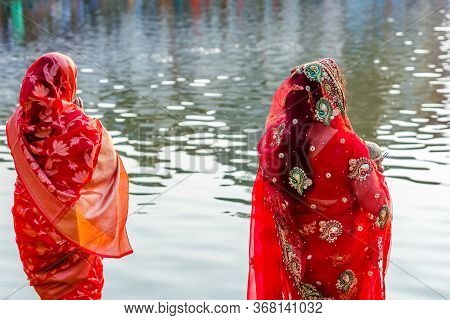 Kathmandu,nepal - November 1,2019: Hindu Devotees Offering Prayers To Sun God Standing In Water Acco