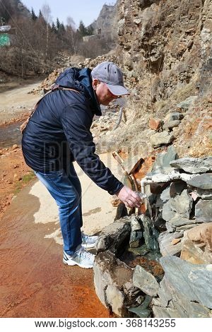 Man Filling Mineral Water In Narzan Valley, Kabardino-balkaria, Russia