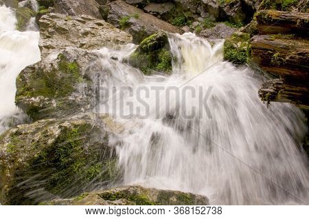 River Forming Waterfalls In Cetatile Ponorului, Apuseni Natural Park, Romania