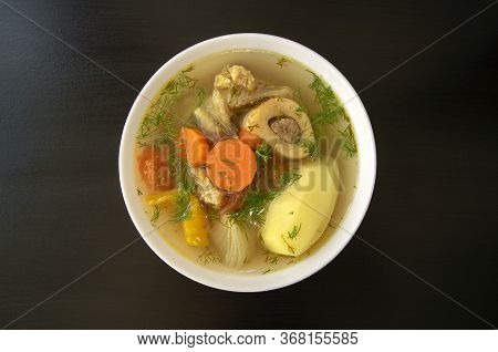 Shurpa Soup In A White Bowl On Dark Wooden Background. Top View. Famous Traditional Asian, Uzbek, Mi