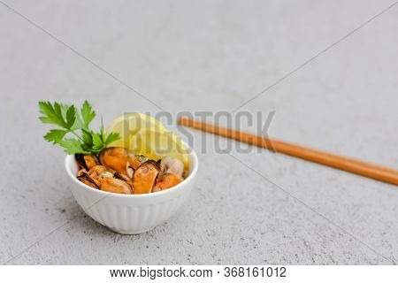 Mussels Without Shell With Lemon Slices In White Ceramic Bowl. Seafood Concept. Selective Focus. Spa