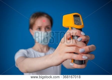 Healthcare, Measurement, Disease, Infection, Coronavirus Concept. Woman In Medical Face Mask Holding