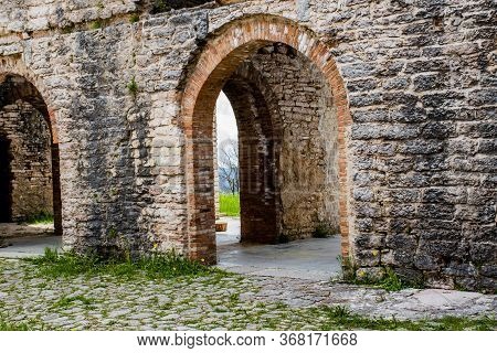 Ancient Walls Rich In History, Bricks And Stones, Arched Doors And Windows Open Glimpses Of Mountain