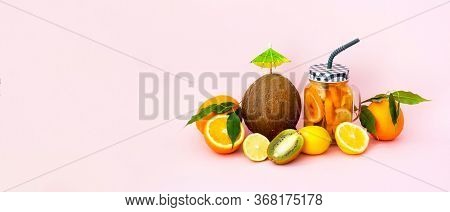 Quarantini Or Homemade Alcohol Drink With Coconut Milk And Tropical Fruits On Pink Background. The C