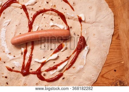 Ingredients For Home-cooked Shaverma. Sausage, Cucumber, Grilled Vegetables Lie On A Pita