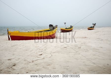 Fishing Boats On The Beach On A Cloudy And Foggy Day. Baltic Sea, Poland