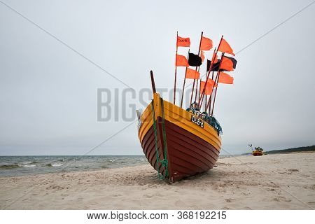 Debki, Poland- May 25, 2020: Fishing Boat On The Beach On A Cloudy And Foggy Day. Baltic Sea, Poland