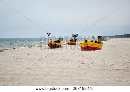 Fishing Boats On The Beach On A Cloudy And Foggy Day. Baltic Sea, Poland