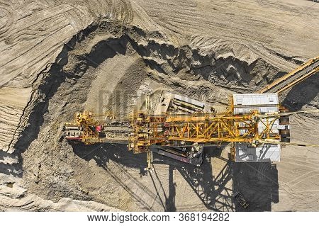 Aerial View Of Large Heavy Equipment Machine Mining Natural Resource. Coal Mining By Bucket Wheel Ex