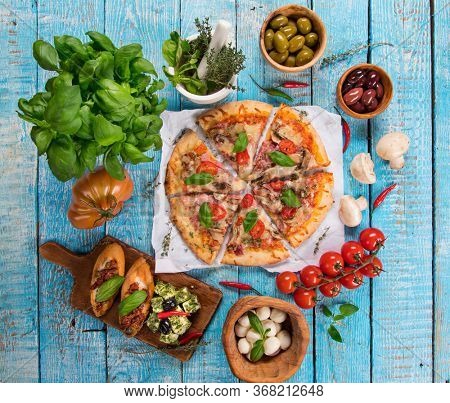 Top view of traditional italian fod on vintage wooden background. Food concept for menu.