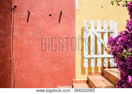 Bright Colorful Courtyard Somewhere In A Small Spanish Town. Concept Travel And Tourism.