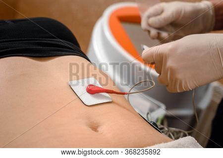 Fat Client Getting Myostimulation Procedure For Weight Loss In Beauty Salon