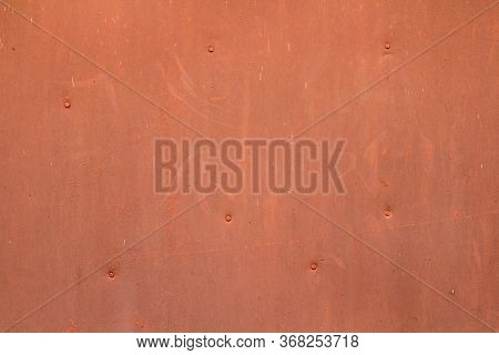 The Wall Is Red Orange With Scratches And Scuffs. Painted Iron Sheet Nailed. The Background For Text