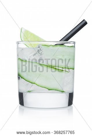 Gimlet Cocktail In Glass With Ice Cubes And Straw, Cucumber And Lime Slice On White Background.