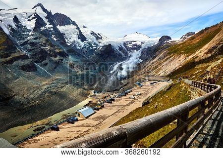 Panoramic view at Pasterze Glacier Grossglockner among austrian Alps mountains summits blue sky clouds.