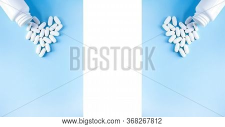 Pills Of Vitamin In The Shape Of Heart With The Opened White Plastic Container On Soft Blue Backgrou