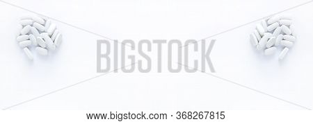 Pills Of Vitamin In The Opened White Plastic Container. Medical Theme Background. Long Banner