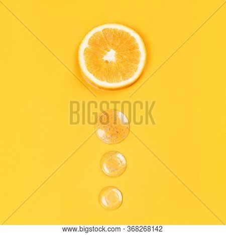 Orange Slice And Three Round Drops Liquid Gel On An Orange Background Vitamin C Medical Concept Flat