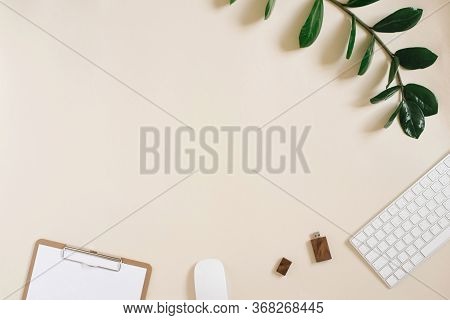 Modern Desktop Of A Freelancer Or Blogger With A Keyboard, Mouse, Pen, Usb Drive And Notepad With A 