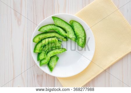 Green Slices Of Succade Of Pomelo On White Plate On Wooden Table. Candied Citrus, Confectionery Conc