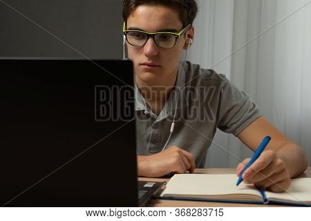 Focused European Man Wearing Glasses Watching Webinar Training Making Notes Study Online Learning La