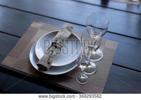 Served Wooden Table With Three Empty Wineglasses