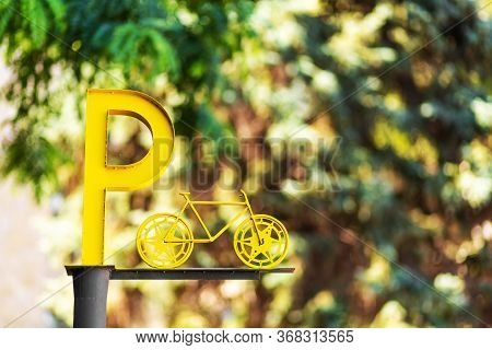 Designation Of Parking For Bicycles. Big Yellow Letter P On A Pillar.