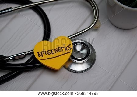 Epigenetics Write On Sticky Note Isolated On Wooden Table. Medical Concept