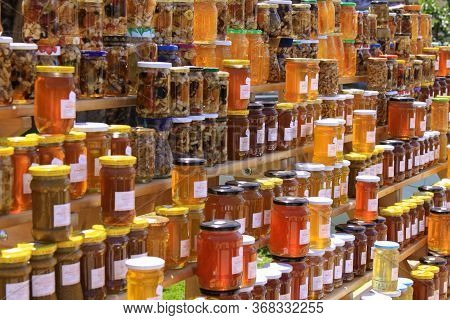 RazvrŠje, Montenegro - June 04 2018: Shelves With Various Types Of Honey Jars. Honey Is A Sweet, Vis
