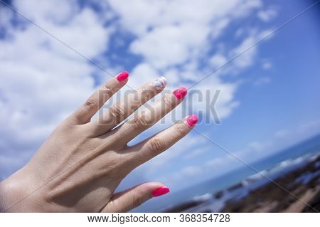 Womans Hand Showing Her Semipermanent Manicure. Pink Colour