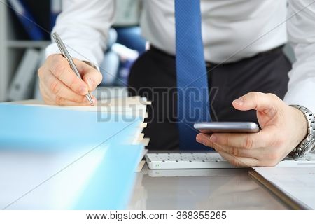 Businessman Signs Stack Documents In Table Office. Man Created Workplace At Home During Quarantine. 