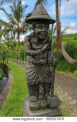 Statue Of A Rice Farmer Near The Rice Field. Balinese Jatiluwih Village. Bali, Indonesia.