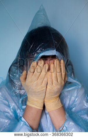 Woman In A Protective Suit Closing Her Face. Distressed Woman. Coronavirus (covid-19) Disease Outbre