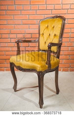 Vintage Old Black Wooden Chair In Grungy Interior. Loneliness, Estrangement, Alienation Concept.