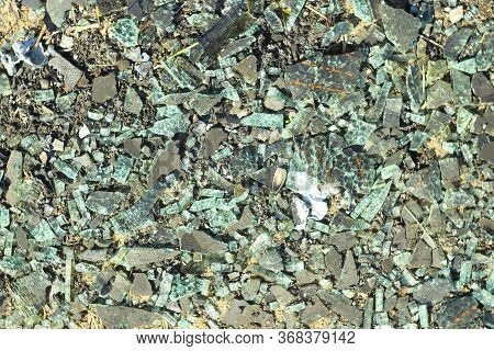 Small Broken Glass And Construction Debris. Fragments Of A Broken Kinescope And Monitor. The Backgro