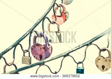 A Lot Of Aged And Vintage Metal Padlocks With Rusty Metal From Corrosion Are Fixed On A Metal Base. 