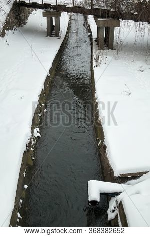 Urban Stream In Winter. The Lybid River (kyiv, Ukraine) In The Snow.