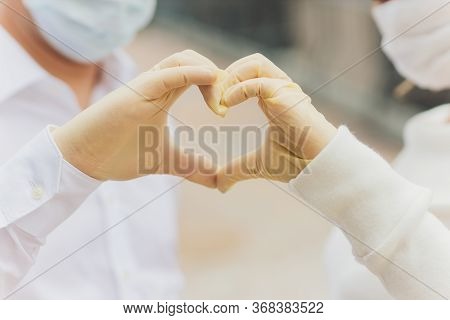 Two Hands Of A Couple In Plastic Gloves Holding Each Other. Virus Protection Concept, Health Issues,