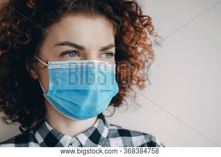 Close Up Photo Of A Caucasian Woman With Red Curly Hair Wearing A Medical Mask During The Pandemic P